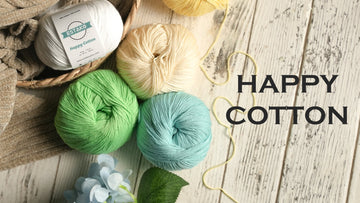 Estako Happy Cotton balls in soft pastel colors beside a flower, ideal for crochet flowers