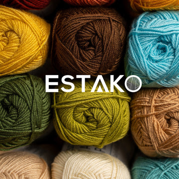 Overhead grid of multicolored Estako yarn balls in yellow, brown, teal, green, olive and cream with the Estako logo | Estako