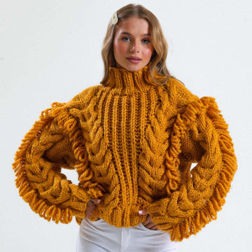 Mustard chunky cable-knit cardigan made with Estako Cozy yarn on a rustic wooden table, Grandmacore 2026 aesthetic