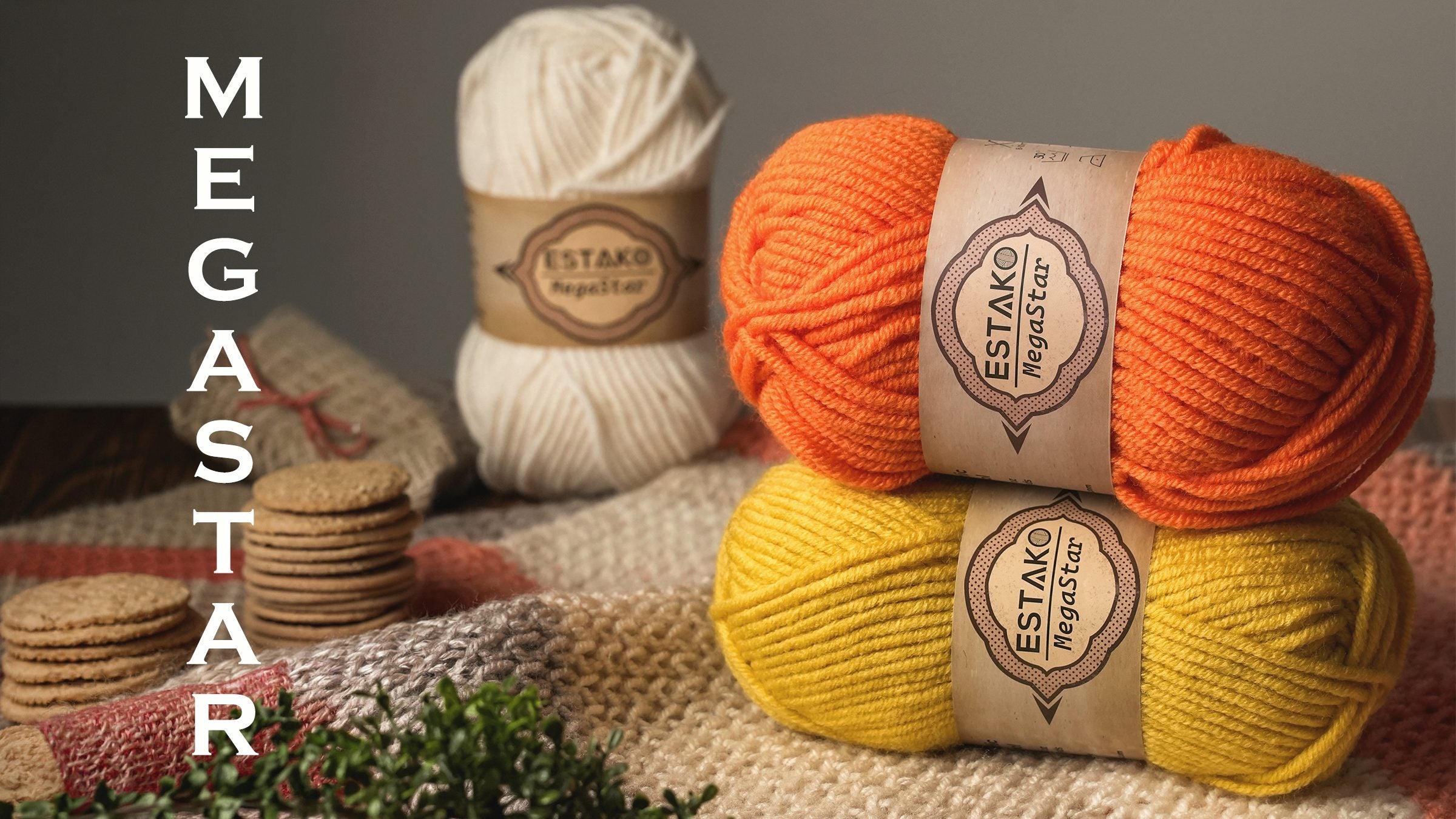 Estako MegaStar bulky wool blend skeins in cream, orange and yellow, the kind of multi-skein haul to buy in one dye lot.